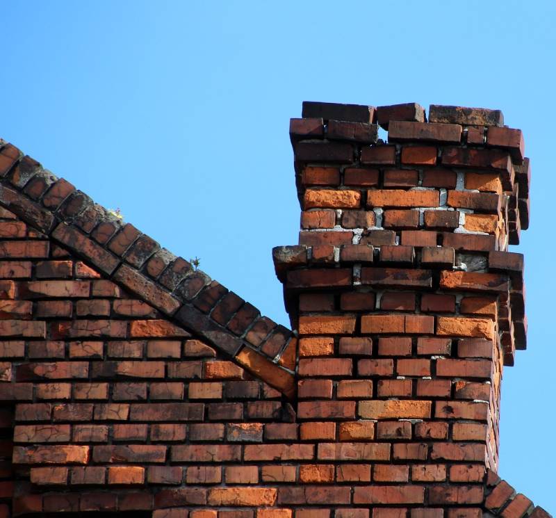 Signs Your Adelphi Home Needs a Chimney Inspection Damaged chimney on an Adelphi home showing cracks and missing mortar